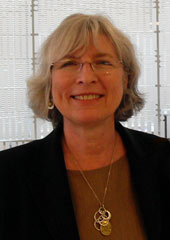 Marvel Pomeroy smiling in front of an Erikson conference room
