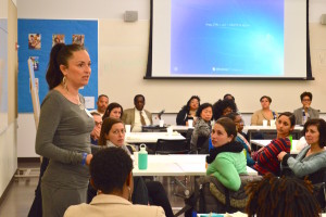 Adenia Linker, M.Ed., left, project manager for Erikson's Calm Classroom K-2 program, asks a question during a panel discussion at Erikson honoring The Rev. Dr. Martin Luther King Jr.'s legacy.