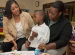 Teacher, parent, and student working together at a Child-Parent Center