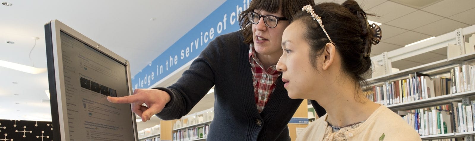 Librarian helping student