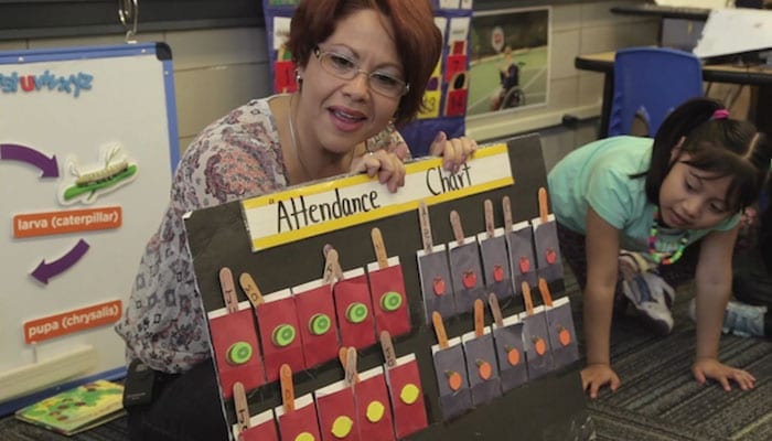 Female teacher teaching math to children.