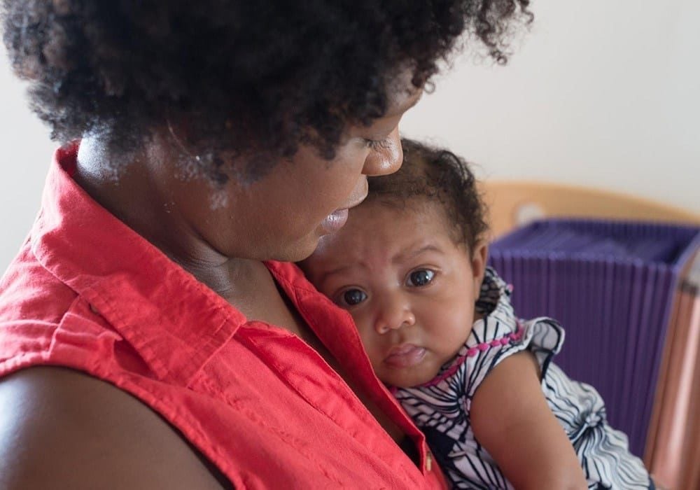 image of woman holding a baby