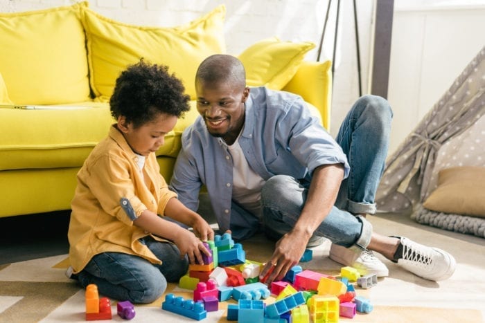 smiling-african-american-father-and-little-son-playing-with-colorful-blocks-together-at-home