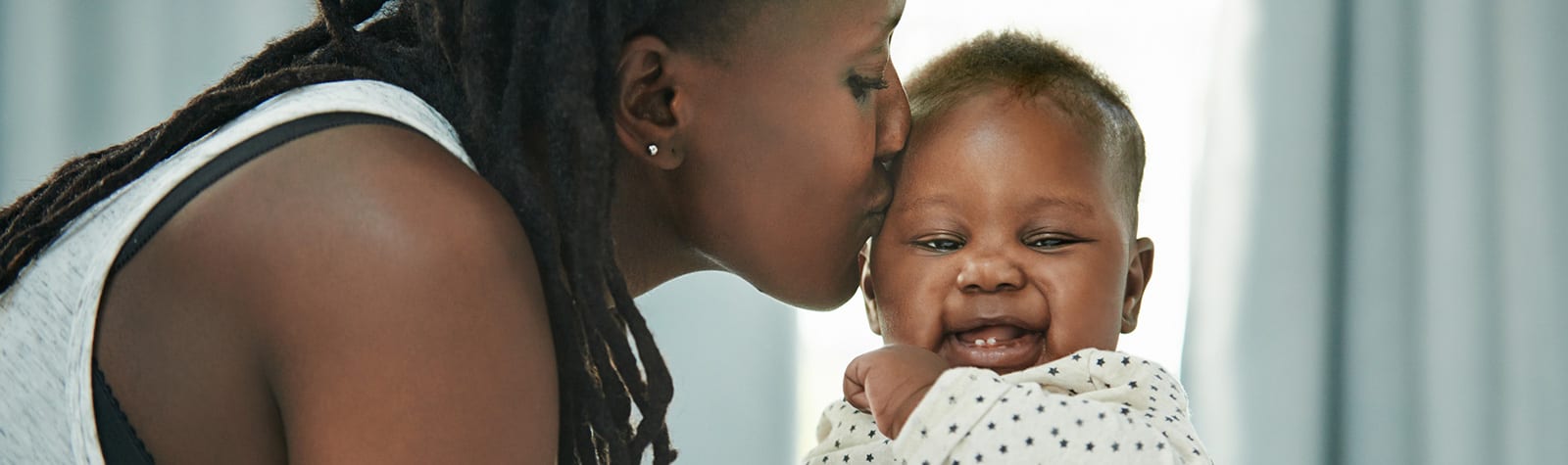 Mother and her newborn baby at home