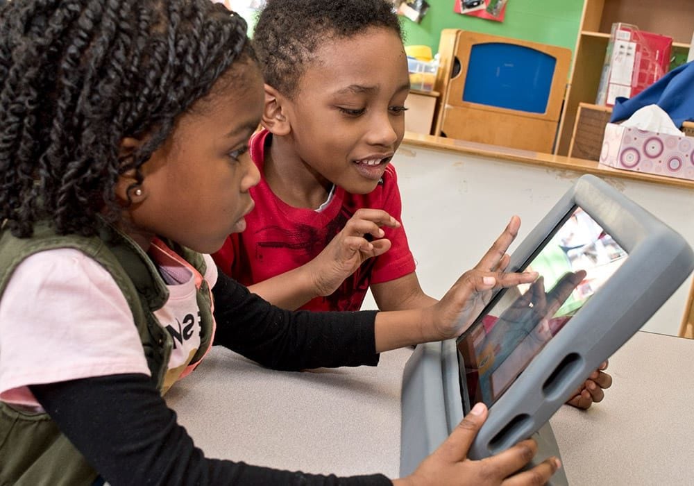 Children in classroom with tablet