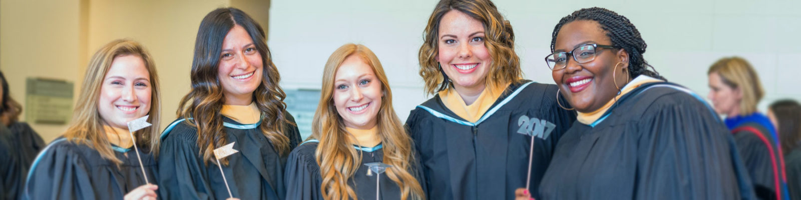 students smiling together at commencement