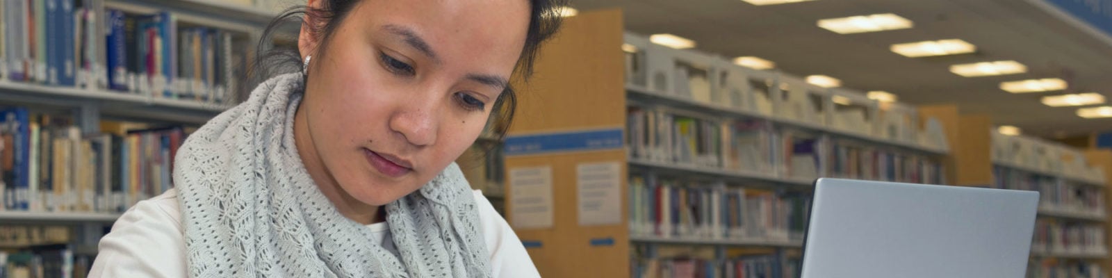 Young woman studying in a library.