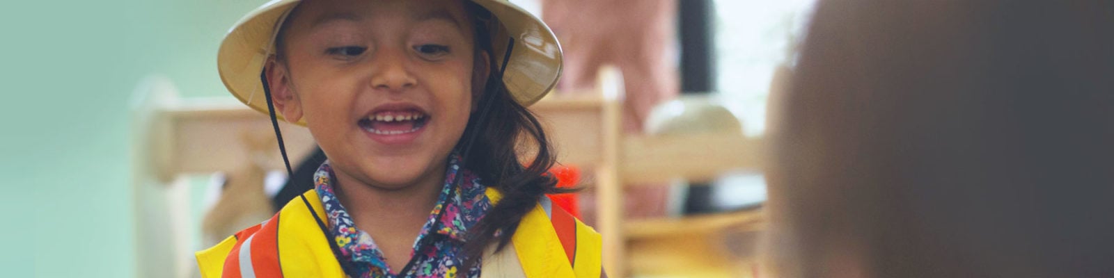 child at table smiling