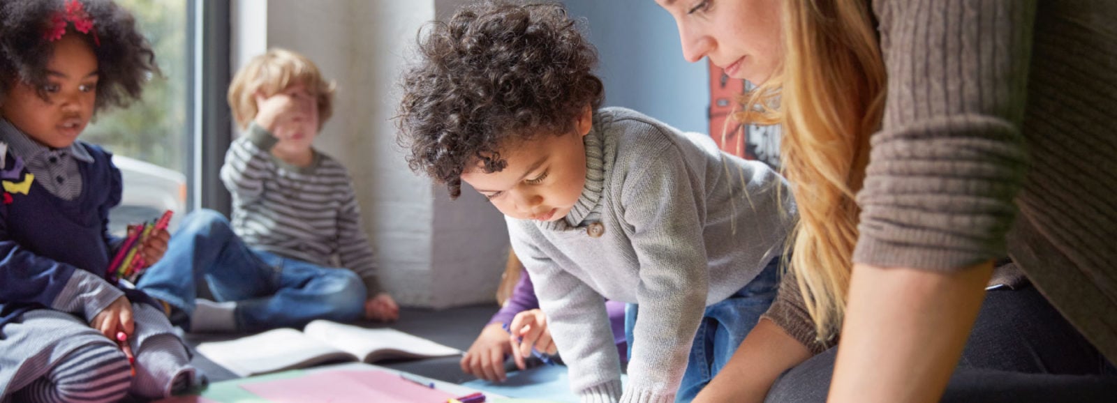 A children’s therapist working with several young children.