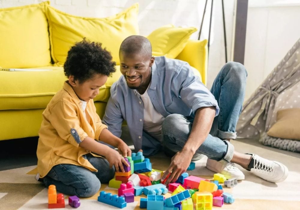 Man and child playing with blocks