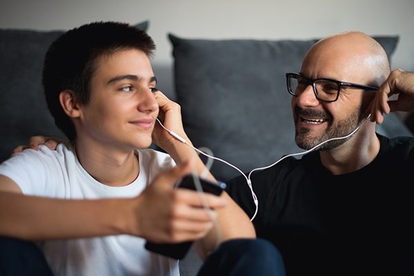 Father and son listening to music