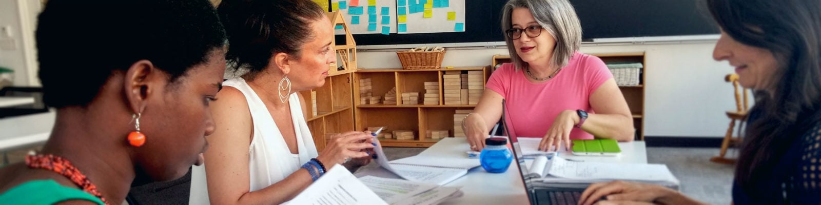 PhD Child Development candidates studying together in a classroom.