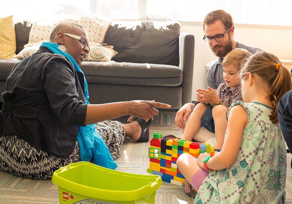 A children’s therapist working with a family.