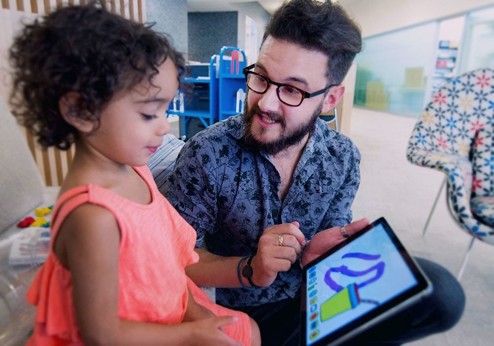 A teacher and student using an ipad