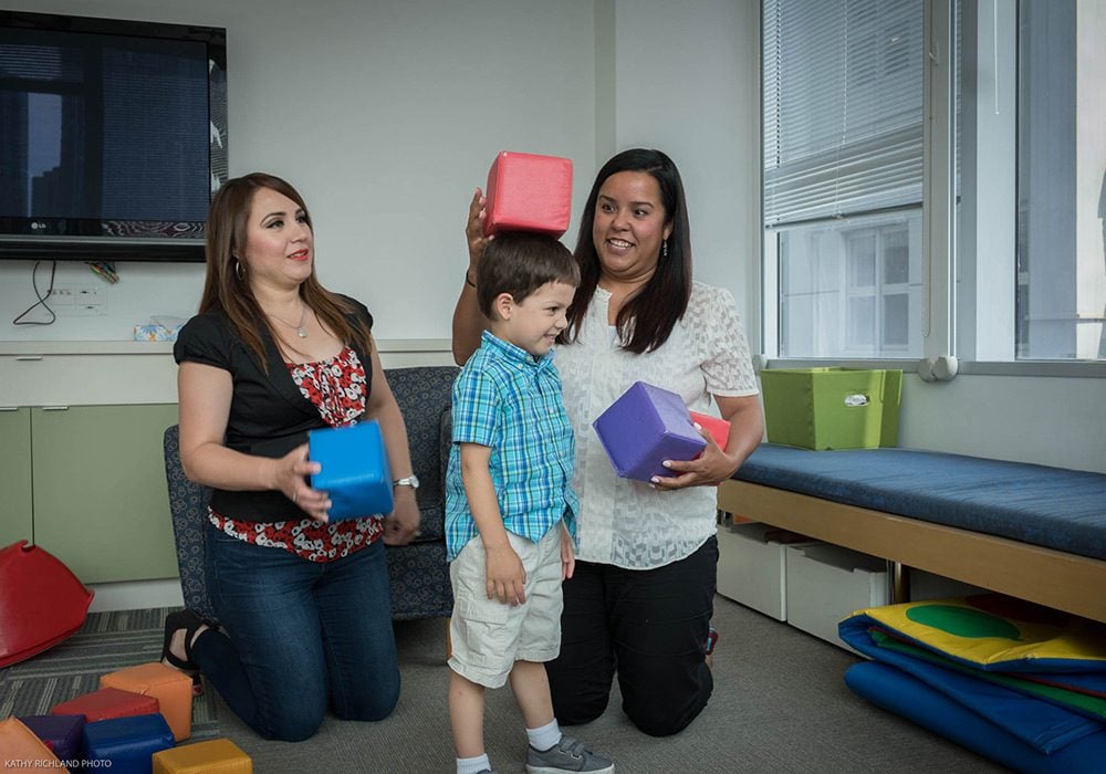 A pediatric mental health specialist and a mother working with a preschooler.