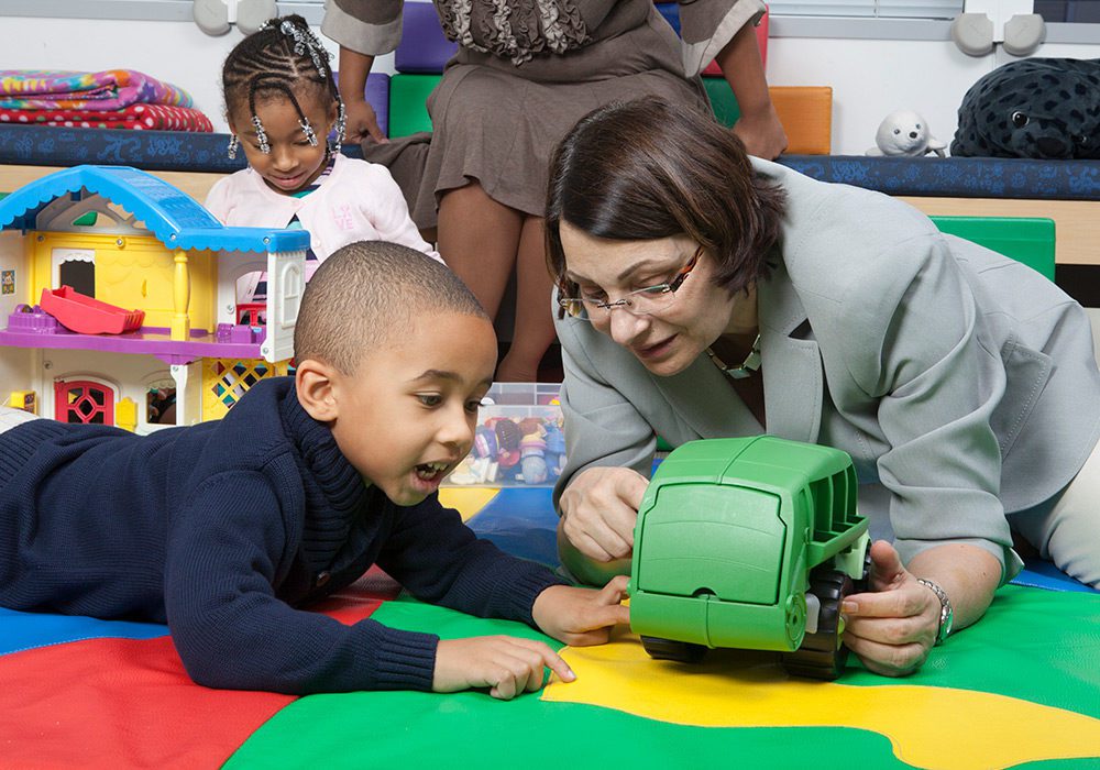 A children’s therapist working with a toddler.