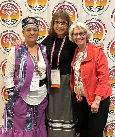 Dr. Linda Gilkerson at the 2023 Indigenous Home Visiting Meeting with Karla Decker-Sorby, the Senior Public Health Nurse for the Minnesota Department of Health, and Birdie Lyons, Leech Lake Band of Ojibwe and Family Spirit Program Manager. 