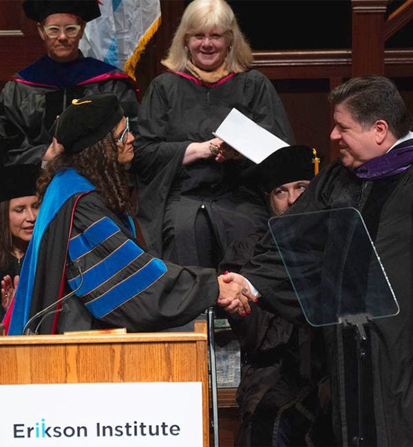 Erikson President Mariana Souto-Manning shaking hands with Governor JB Pritzker