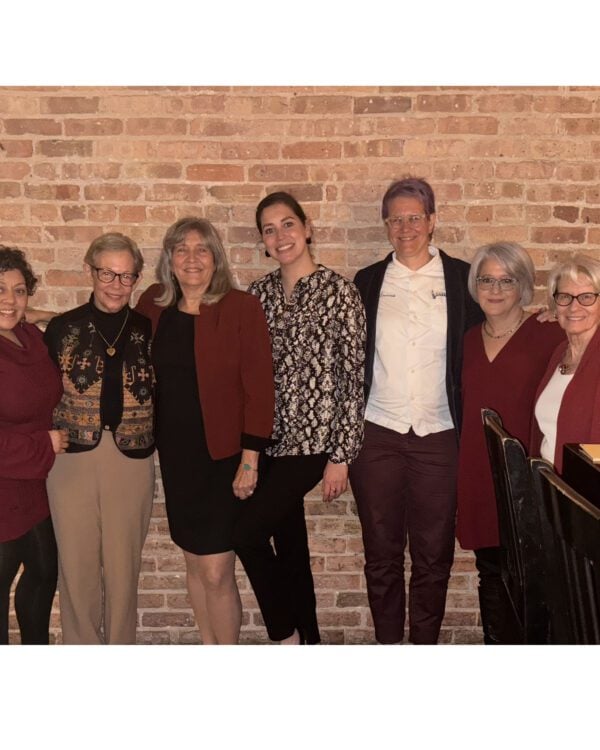 L-R, Dean of Faculty Maxine McKinney-deRoyston, Commencement keynote speaker Adele Diamond, doctoral chair Cynthia García Coll, doctoral candidate Kia Ferrera, Senior Instructor Jeanette Banashak, Associate Professor Amanda Moreno, Professor Linda Gilkerson.