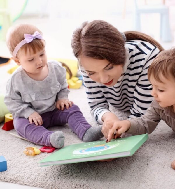 Early childhood professional working with a toddler in a home setting as part of an early intervention visit.