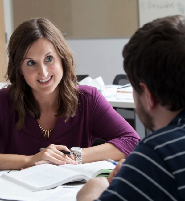 Two social work graduate students in a reflective conversation during a training session