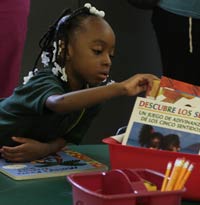 Catalyst Circle Rock Charter School student looking at children's books