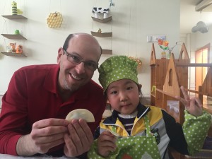 Erikson President and CEO Geoffrey A. Nagle, Ph.D., gets a lesson on making dumplings at an early childhood center in China.