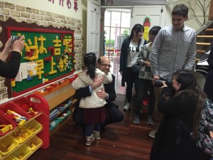 Dr. Nagle receives a warm welcome from a student at Shanghai Nanxi Preschool.
