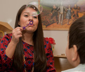 Alumni Rios working with a child.